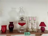 Shelf of red décor- lamp; cases; Candle Sticks