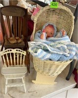 Doll in bassinet, rocking chair, high chair all