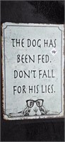 15" X 10" "The dog has been fed" metal sign