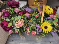 2 floral arrangements one in a basket