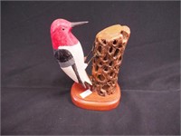 Handcarved wooden figure of a red-headed