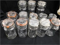 13 clear glass jars. 3 are embossed Wheaton on