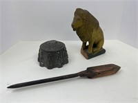 Hog scraper, metal mold, and wooden lion