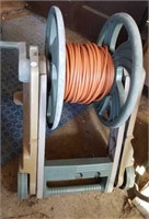Long industrial extension cord on hose reel