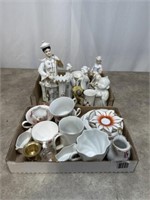 Cups, saucers porcelain / ceramic figures tallest