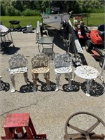 3 cast iron metal chairs and circular table.