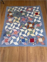 Old hand stitched pinwheel quilt with blue stripe