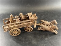 Antique cast iron horse drawn carriage with two ho