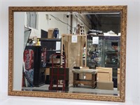 Gilt framed beveled wall mirror