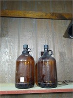 Two old gallon amber jugs