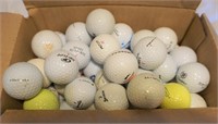 box of used golf balls
