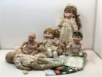 Assorted collectible porcelain posable dolls.