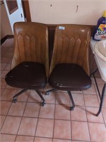Two vintage rolling kitchen chairs