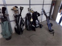 4 golf bags with clubs and cart