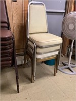 Four padded stackable chairs