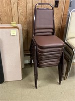 Eight padded stackable chairs