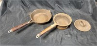 Two cast iron pans and wooden handles (no name)