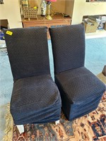 Two blue covered dining chairs