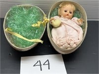 Vintage doll baby inside decorative egg