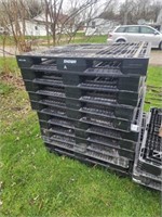 Stack of 11  plastic pallets.