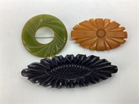 (3) carved Bakelite brooches butterscotch, green