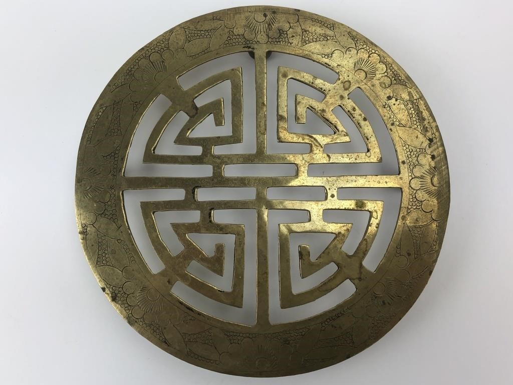 6" round etched China Brass trivet.  Footed and