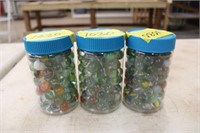 (3) plastic jars of marbles