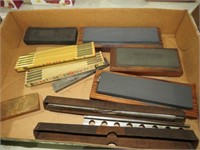 BOX OF VINTAGE WOOD RULERS, BITS, STONE SHARPENERS