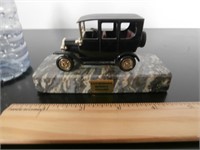 MINIATURE TOY CAR ON MARBLE STAND