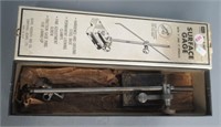 Surface gauge with 9" and 12" spindles and box.