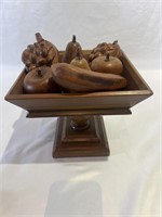 Carved wooden fruit in a wood bowl