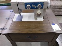 Dressmaker sewing machine in cabinet