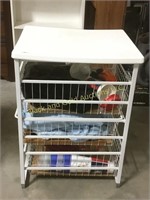 Metal organizing rack with 3 drawers and contents