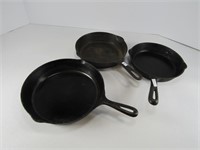 THREE CAST IRON FRY PANS