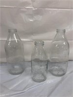 Three early milk bottles