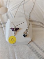 Pair of sterling silver necklaces with charms