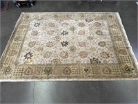 Tan Pattern Area Rug Has Been Repaired