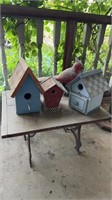 Three wood bird houses, on a old iron leg, short