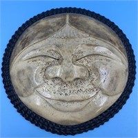 Fossilized whalebone mask with comical carving wit