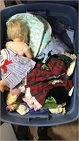 Tote full of dolls and doll clothes