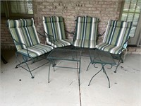 Green wrought iron patio chairs and tables