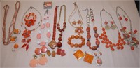Assorted orange and peach necklaces, earrings,
