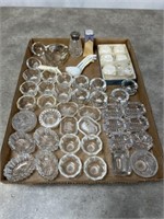 Large assortment of small glass butter dishes,