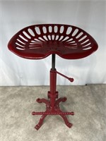 Red painted metal tractor seat with adjustable