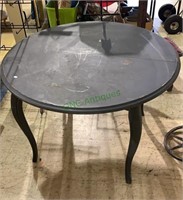 Gray painted dining table with a curvy square