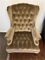 Brown wooden legged wing back chair