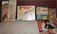 Box full of paper doll sets and books