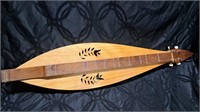 Dulcimer with nicely carved flowers. Inside tag
