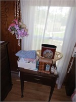 Sewing machine cabinet, items on top, basket.
