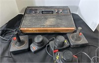 Atari console with controllers and lots